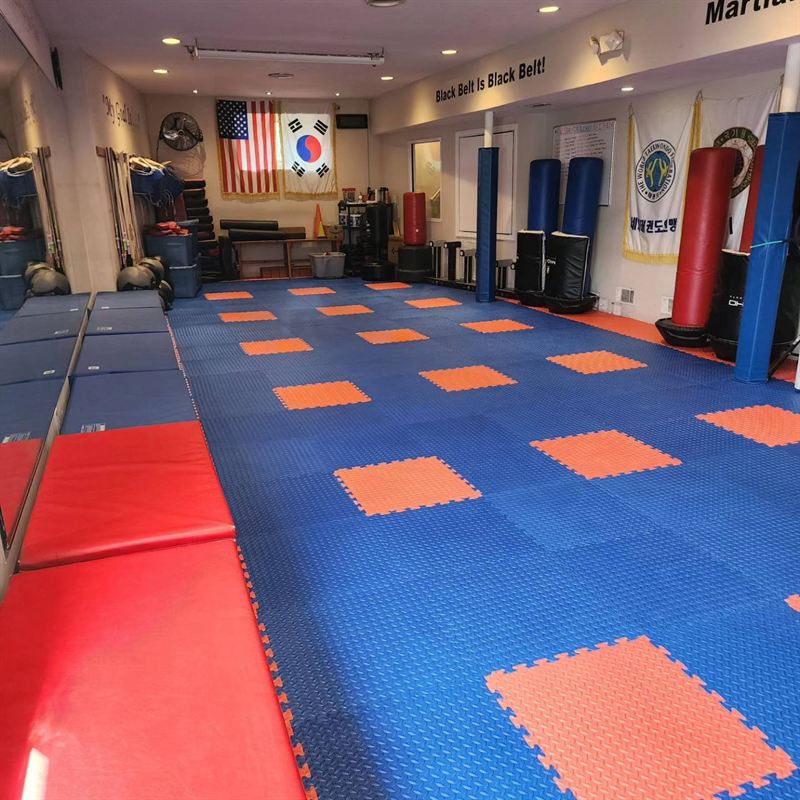 Young children's class group celebration on mats with instructors