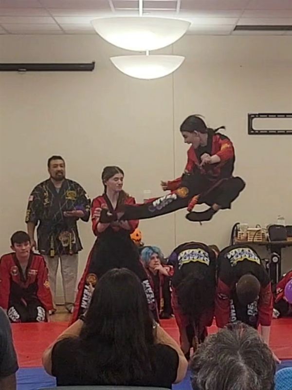 Dedicated students practicing advanced sparring matches on studio mats